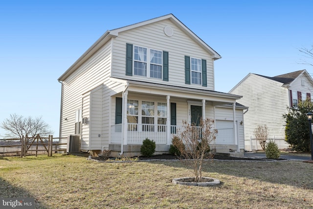 traditional home featuring a porch, fence, a garage, and a front lawn