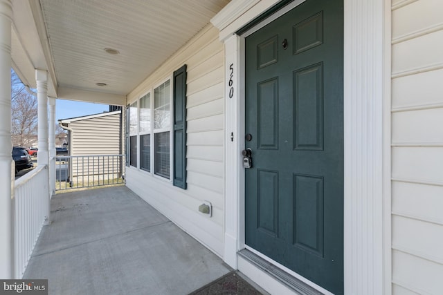 view of exterior entry with a porch