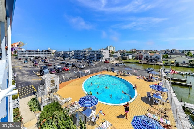 view of pool featuring a water view