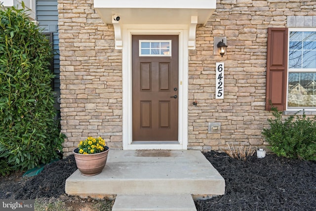 view of exterior entry featuring stone siding