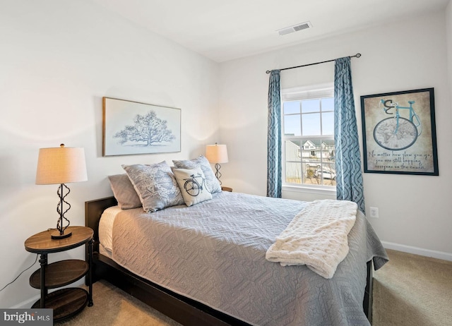 carpeted bedroom with visible vents and baseboards