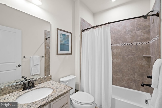 bathroom with vanity, shower / bath combination with curtain, and toilet