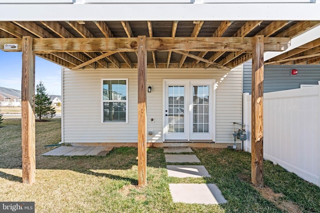 doorway to property with a yard and french doors