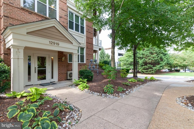 view of exterior entry with brick siding