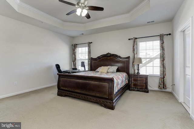 bedroom with visible vents, baseboards, ornamental molding, carpet floors, and a raised ceiling