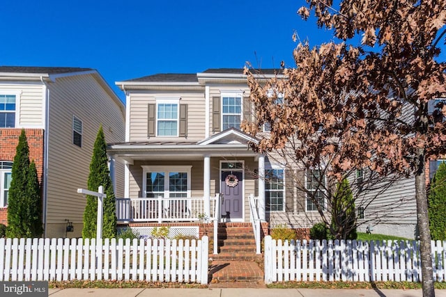 view of front of house with a fenced front yard and covered porch