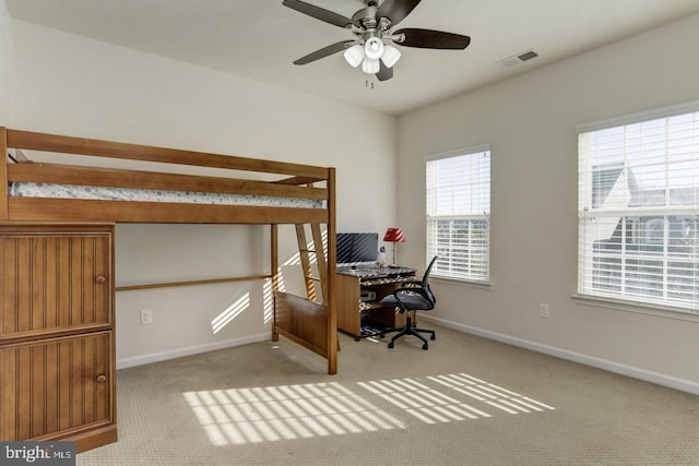 carpeted bedroom with visible vents, ceiling fan, and baseboards