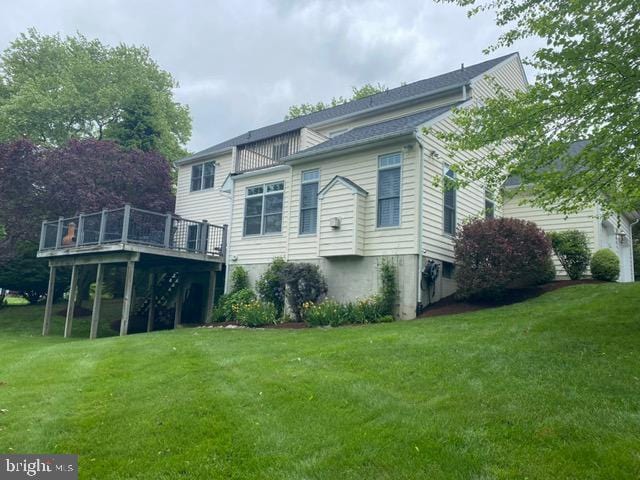 back of house with a yard and a deck