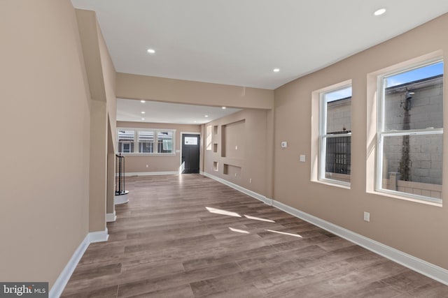 interior space featuring recessed lighting, wood finished floors, and baseboards