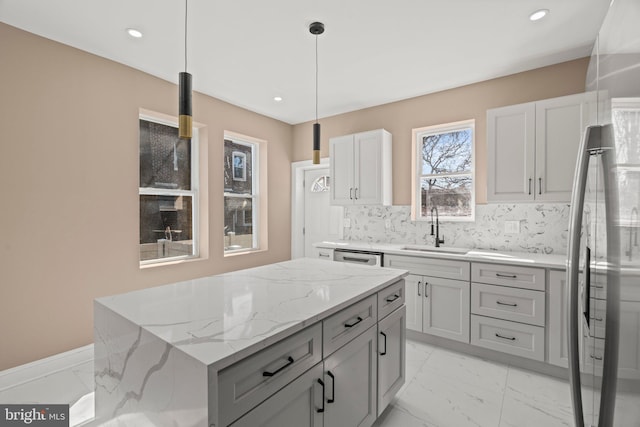 kitchen with light stone counters, tasteful backsplash, marble finish floor, and a sink