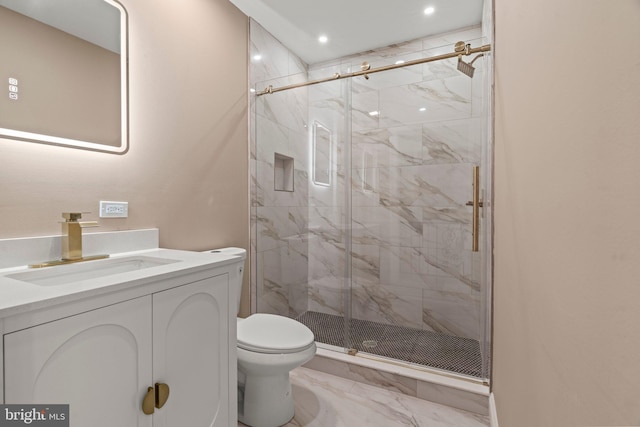 bathroom featuring a marble finish shower, toilet, marble finish floor, and vanity