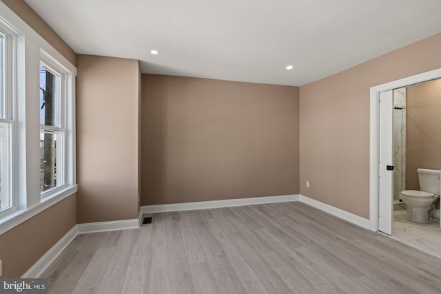 unfurnished room featuring light wood-style flooring, recessed lighting, visible vents, and baseboards