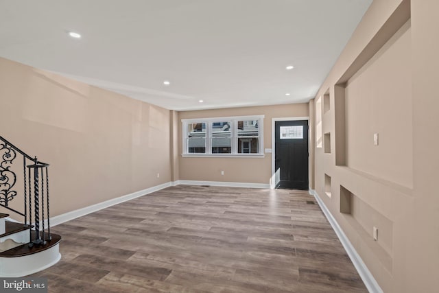 entrance foyer with stairs, recessed lighting, wood finished floors, and baseboards