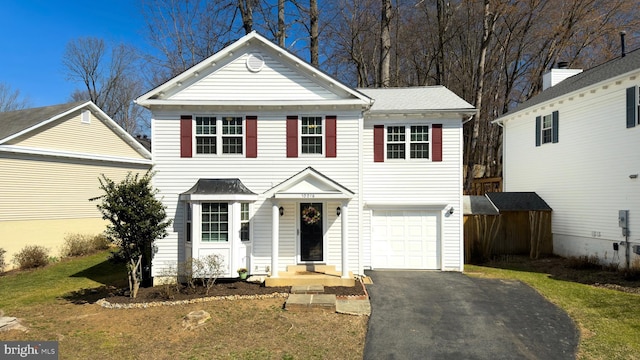 view of front of home featuring aphalt driveway and an attached garage