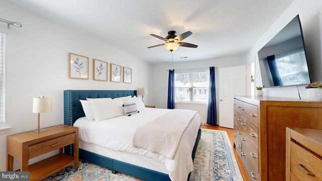 bedroom featuring light wood-type flooring and a ceiling fan