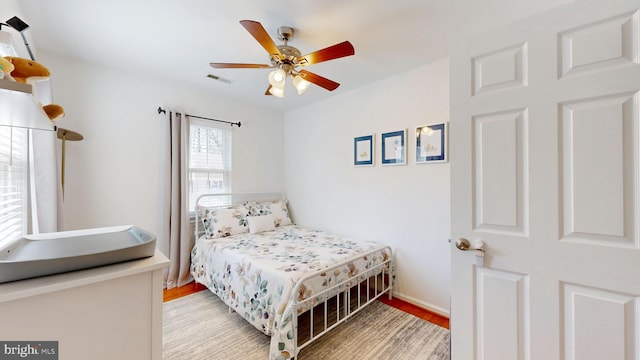 bedroom with visible vents, ceiling fan, baseboards, and light wood-style floors