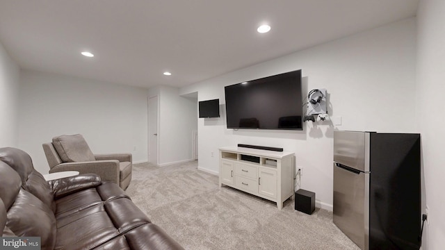 living area featuring recessed lighting, baseboards, and light colored carpet