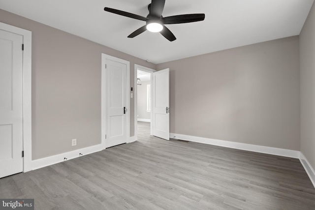 unfurnished bedroom featuring ceiling fan, baseboards, and wood finished floors