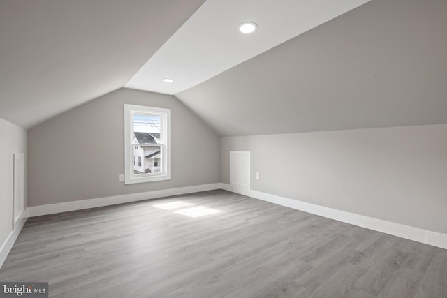 additional living space featuring recessed lighting, baseboards, wood finished floors, and vaulted ceiling