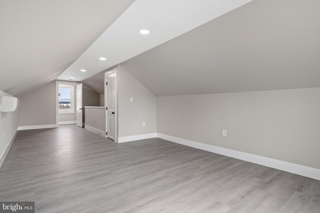 additional living space with vaulted ceiling, recessed lighting, baseboards, and wood finished floors