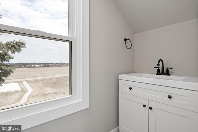 bathroom featuring vanity and vaulted ceiling