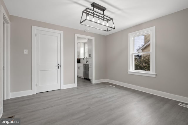 unfurnished dining area featuring visible vents, baseboards, and light wood-style floors