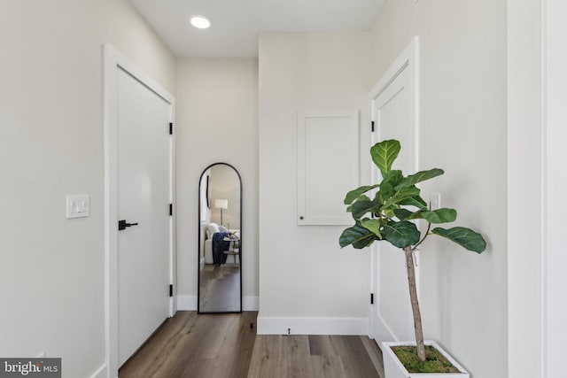 corridor with recessed lighting, baseboards, and wood finished floors