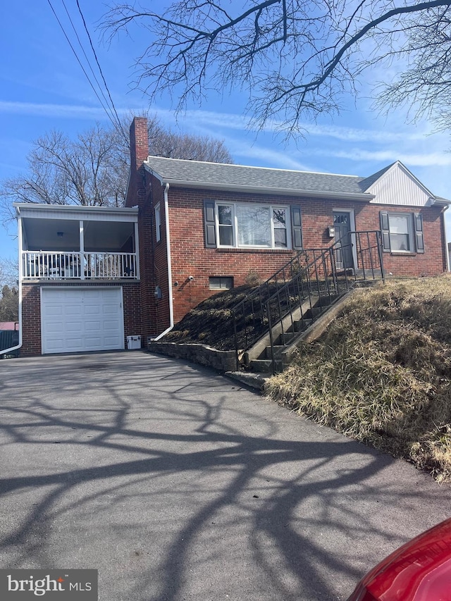 view of front of home featuring an attached garage, brick siding, roof with shingles, and a chimney