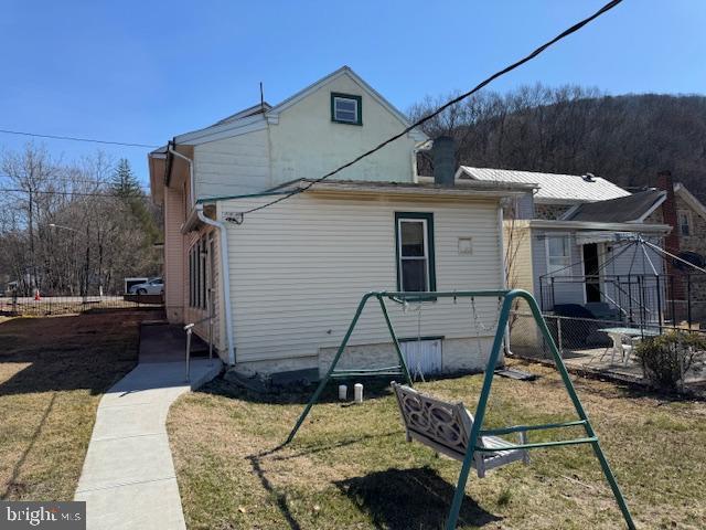 view of side of property with a lawn