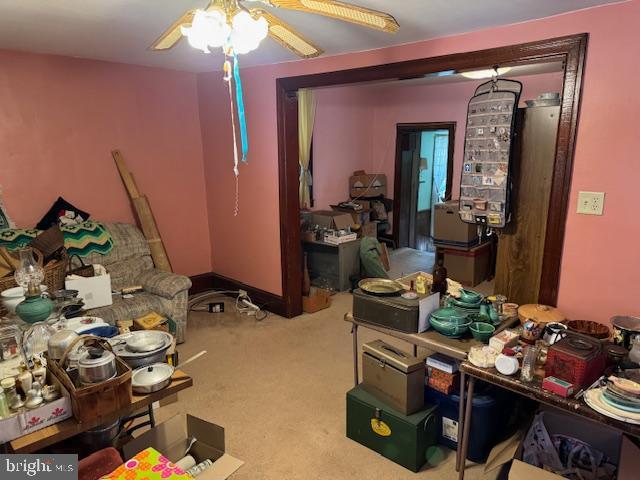 interior space featuring carpet flooring and ceiling fan