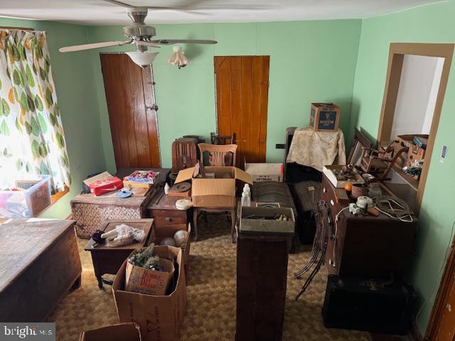 interior space featuring a ceiling fan