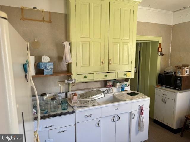 kitchen with light countertops, black microwave, and ornamental molding