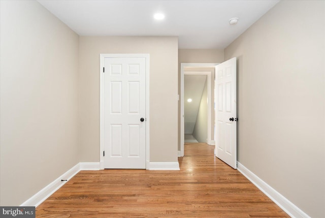 unfurnished bedroom featuring baseboards and light wood-style floors