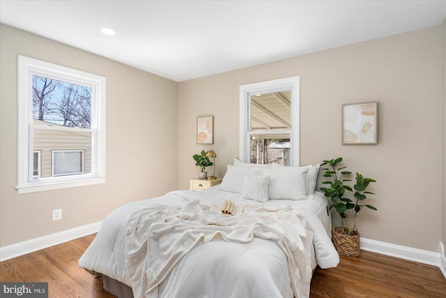 bedroom with recessed lighting, baseboards, and wood finished floors