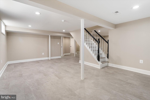 finished basement featuring visible vents, recessed lighting, stairway, and baseboards