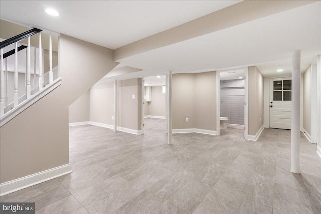 finished below grade area featuring recessed lighting, baseboards, and stairs