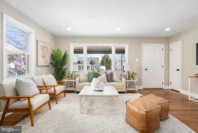 living area with recessed lighting, wood finished floors, and baseboards