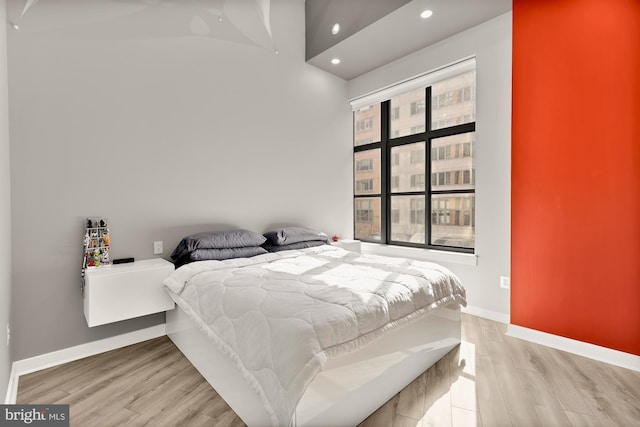 bedroom with recessed lighting, baseboards, and light wood-style floors