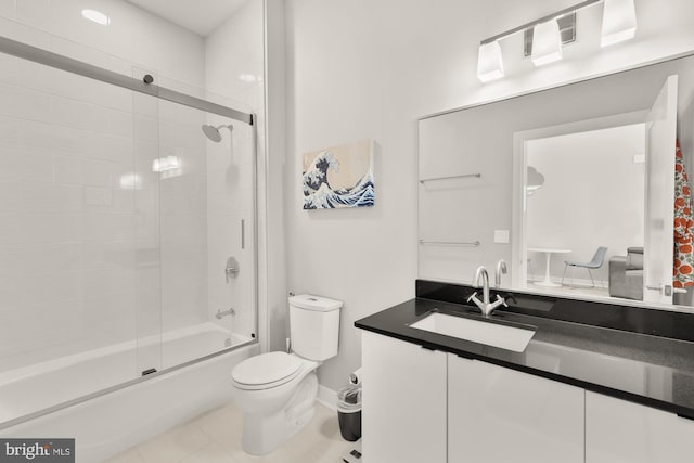 full bathroom featuring tile patterned flooring, baseboards, toilet, enclosed tub / shower combo, and vanity