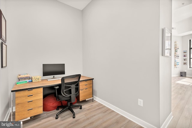 office space with light wood-style floors and baseboards