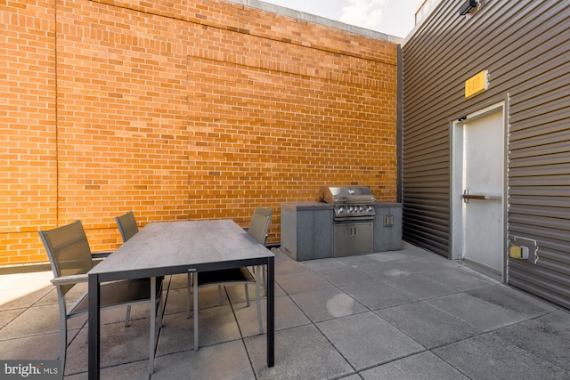 view of patio with area for grilling and outdoor dining area