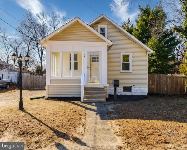 bungalow featuring fence and entry steps