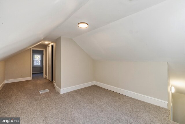 bonus room with vaulted ceiling, carpet flooring, visible vents, and baseboards