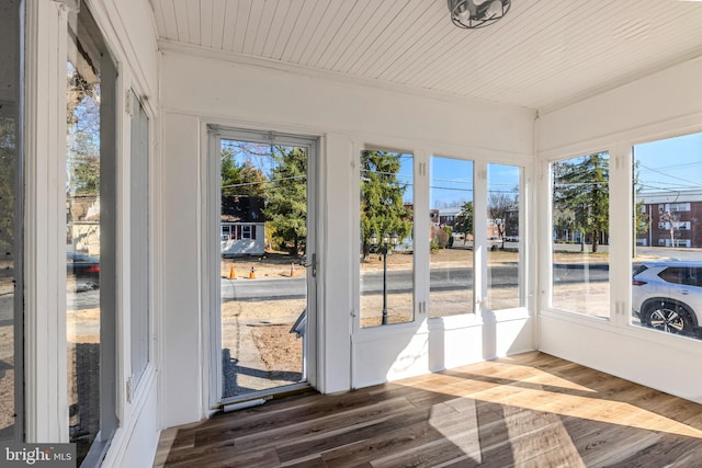 unfurnished sunroom with a healthy amount of sunlight and wood ceiling