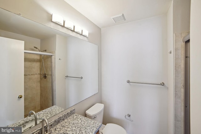 bathroom with visible vents, tiled shower, toilet, and vanity