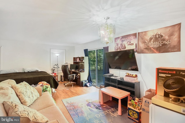 living room featuring an inviting chandelier and wood finished floors