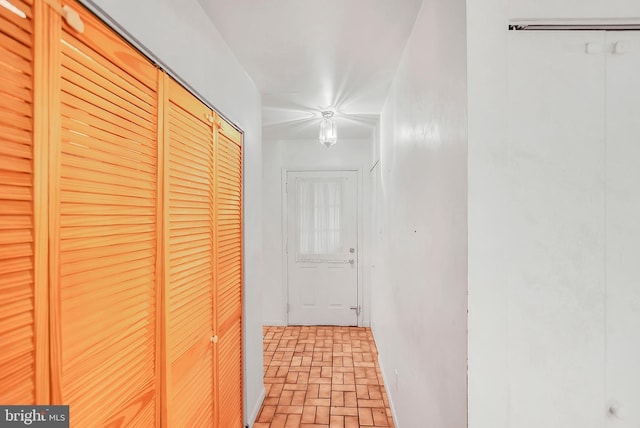 hallway featuring brick floor