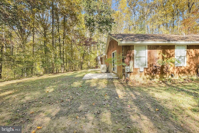 view of side of home featuring a yard