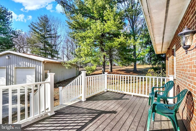 deck featuring a detached garage and an outdoor structure