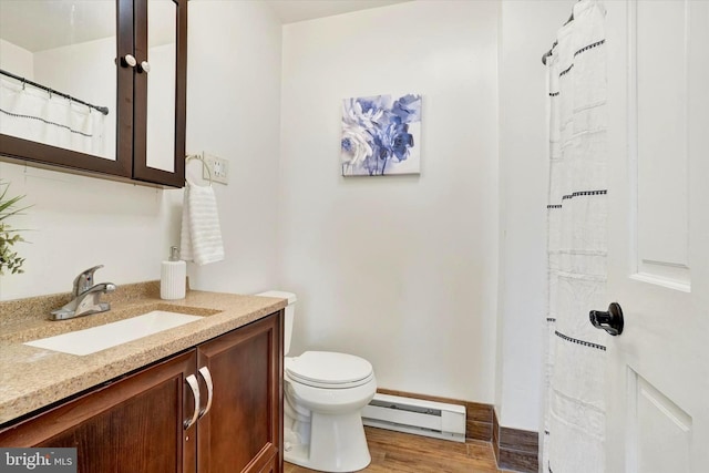 full bathroom featuring a baseboard radiator, toilet, wood finished floors, and vanity